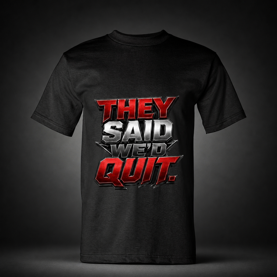 They Said We’d Quit black trucker T-shirt on charcoal studio background